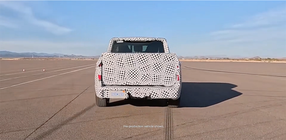 Rear view of the camouflaged Ford Fathom EV pickup during testing