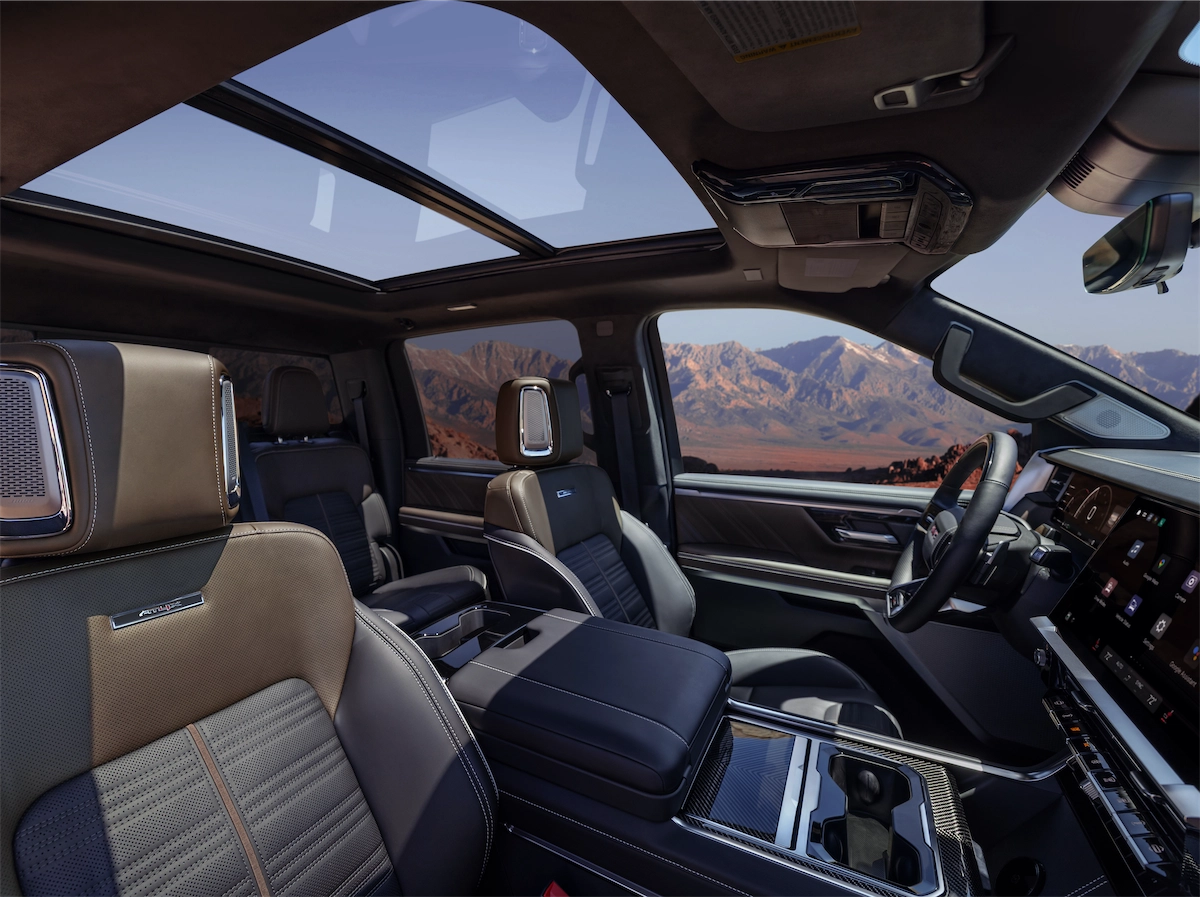Front cabin with a large touchscreen, center console, and panoramic glass roof