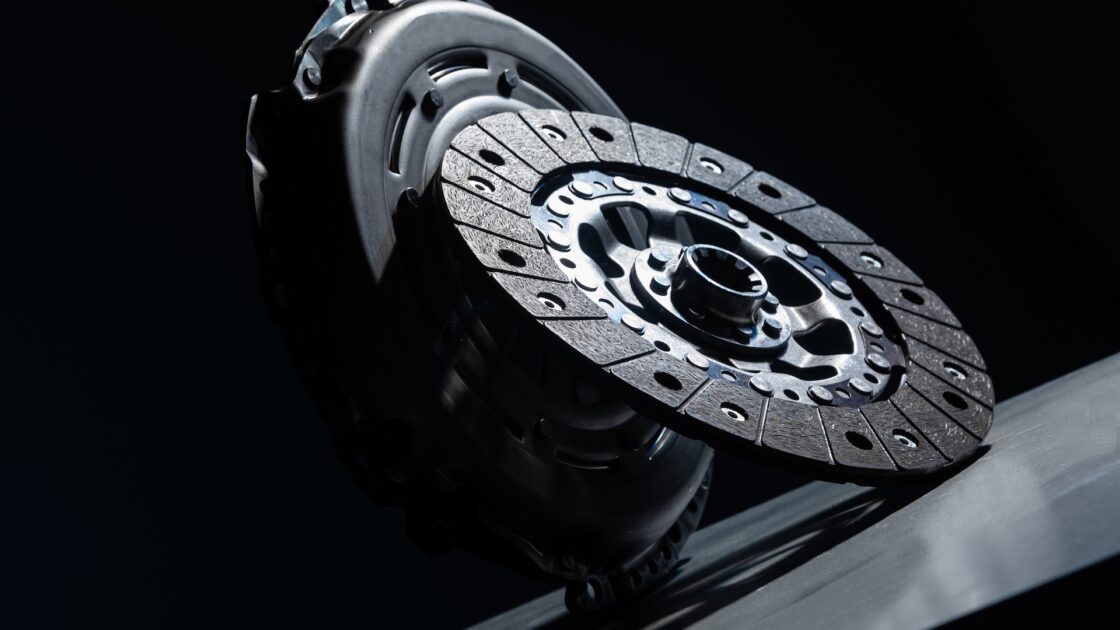 Spare part - clutch disk against black background. Photo with depth of field