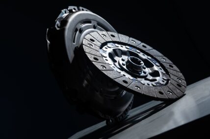 Spare part - clutch disk against black background. Photo with depth of field