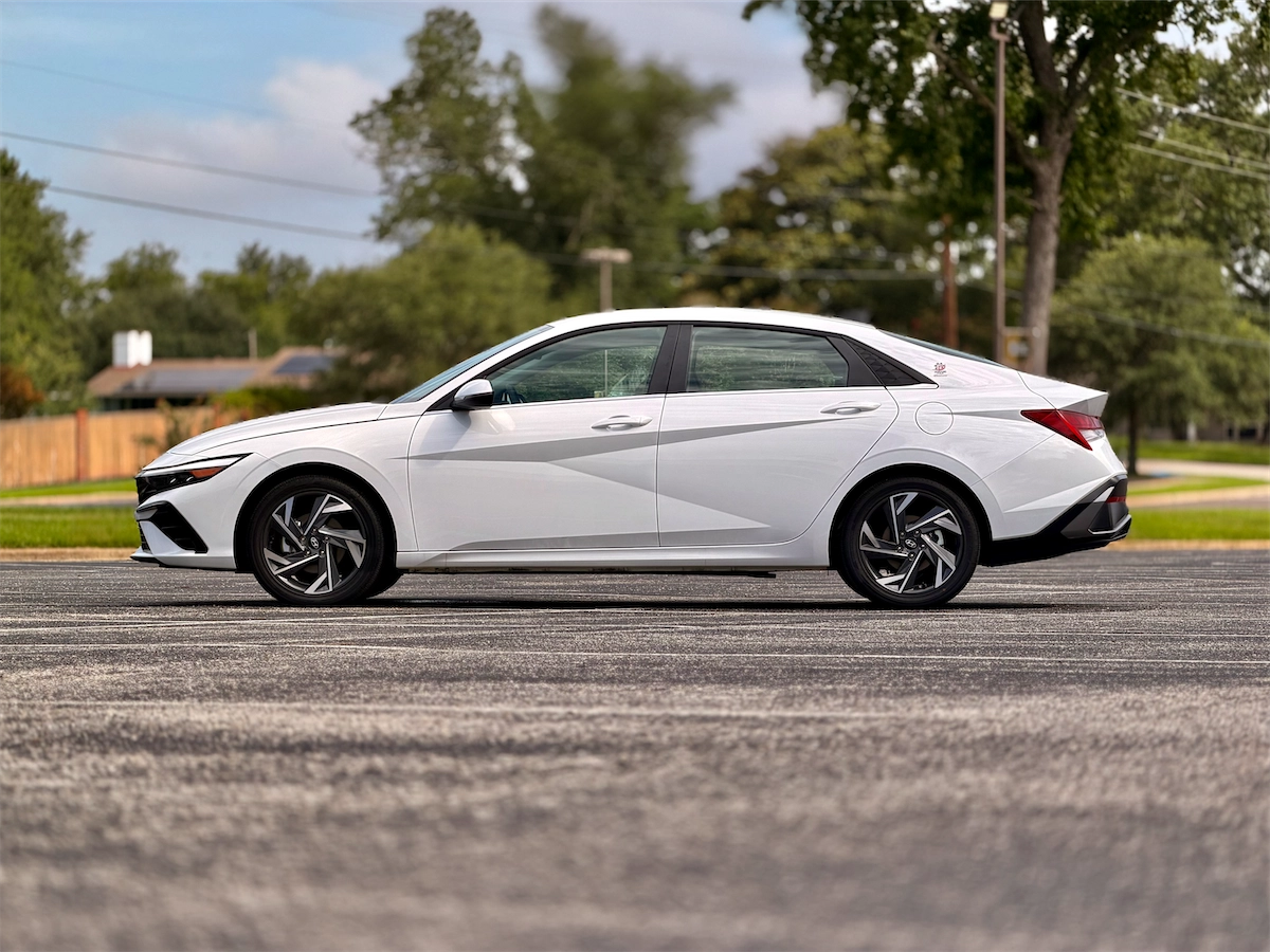 Side profile of the compact sedan in Serenity White