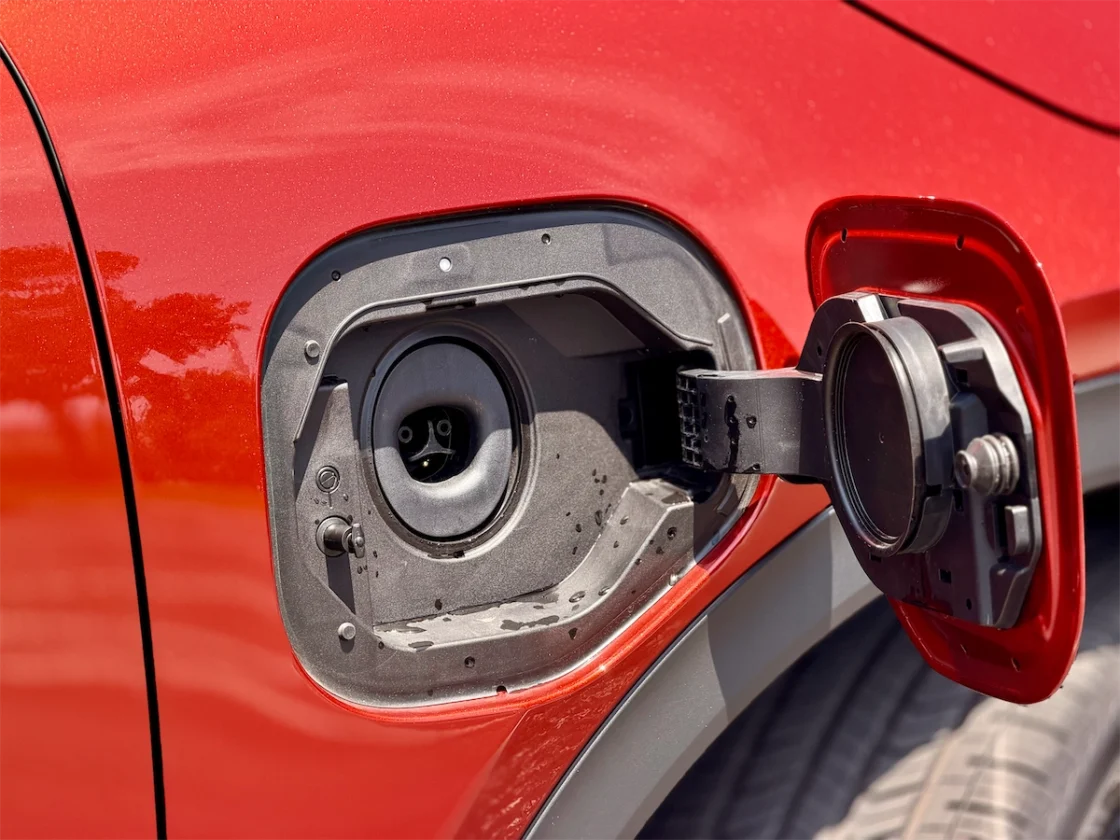 Open NACS charge port on the passenger-side front fender of the 2026 Toyota C-HR XSE