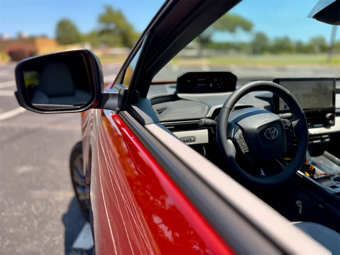 Driver's view over the compact steering wheel and forward digital gauge of the electric crossover