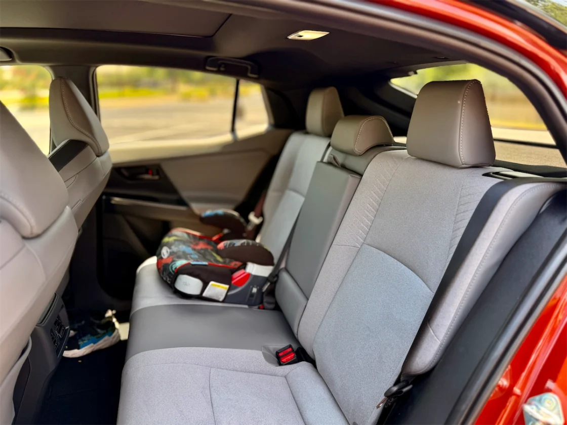 Rear bench seat of the 2026 Toyota C-HR XSE in Birch upholstery with a child safety seat installed