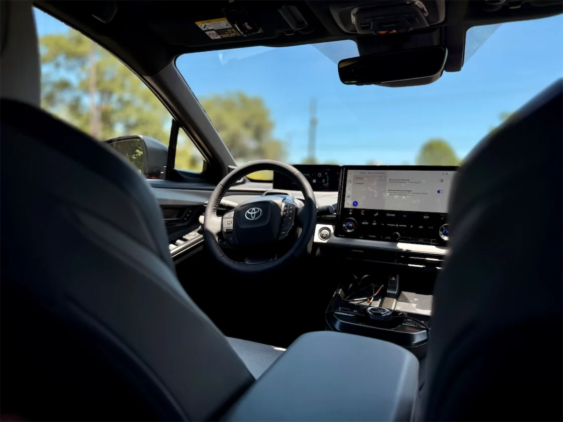 Interior of the 2026 Toyota C-HR XSE showing the compact steering wheel, digital gauge display, and 14-inch touchscreen