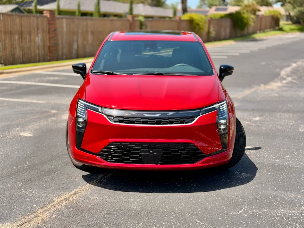 Red 2027 Chrysler Pacifica front three-quarter on a residential street