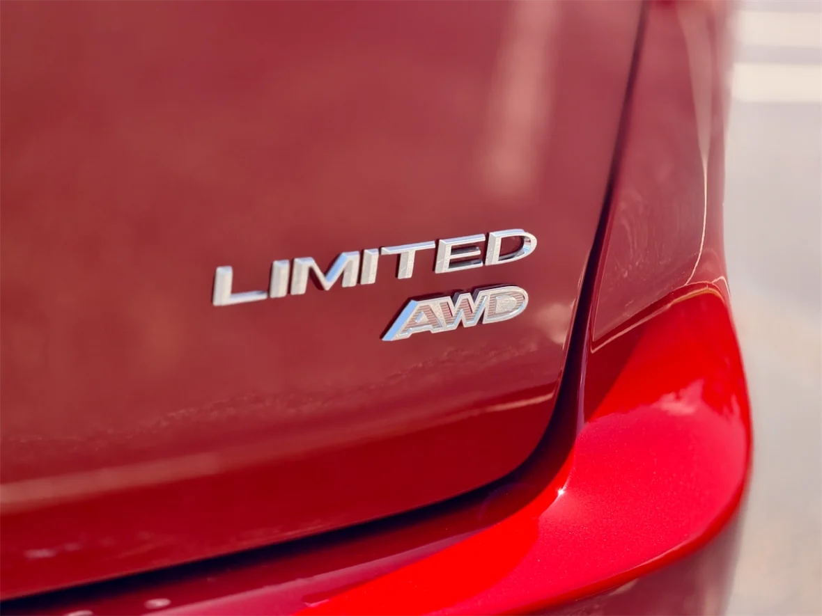 Limited AWD badge on the tailgate of a red 2027 Chrysler Pacifica
