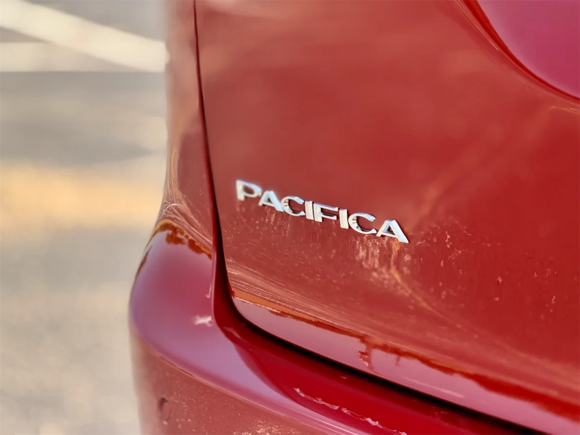 Pacifica badge on the tailgate of a red 2027 Chrysler Pacifica