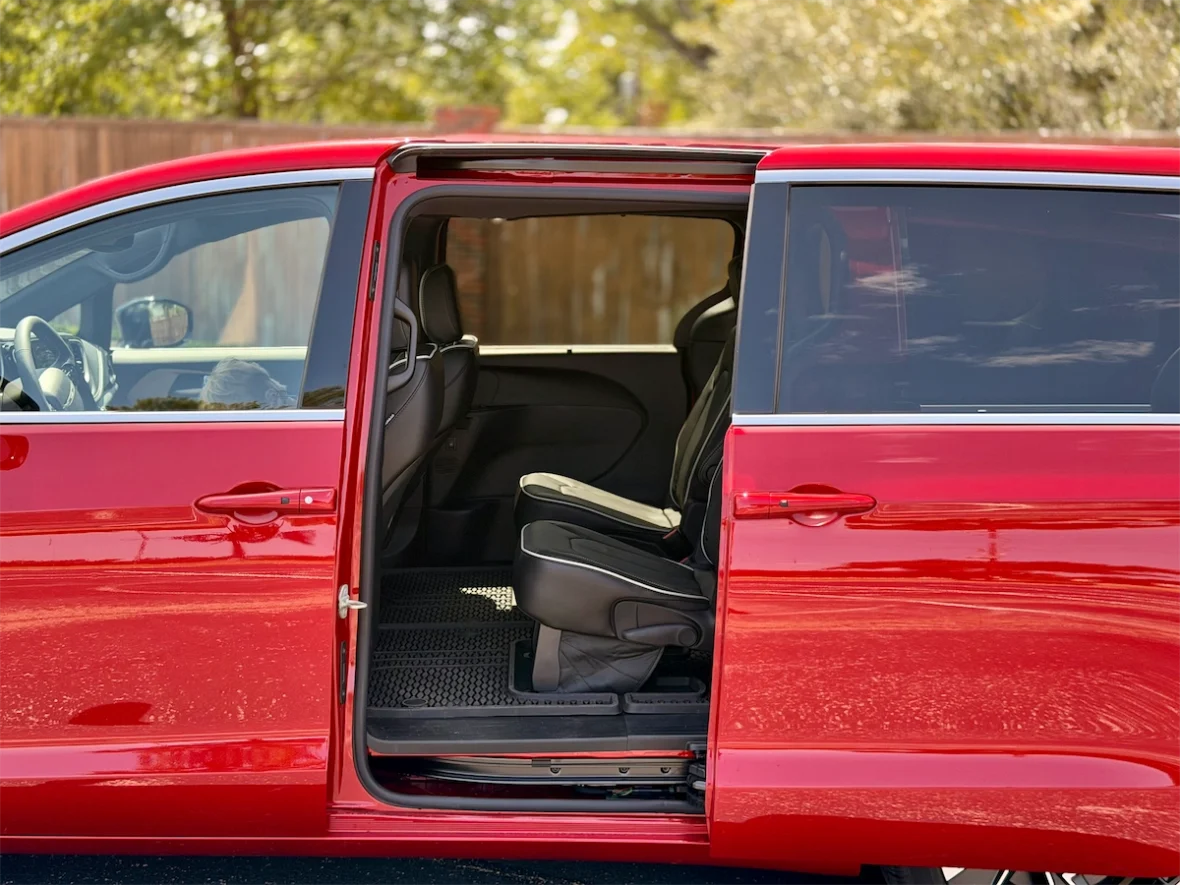 Passenger sliding door open showing a second-row captain's chair on a 2027 Chrysler Pacifica