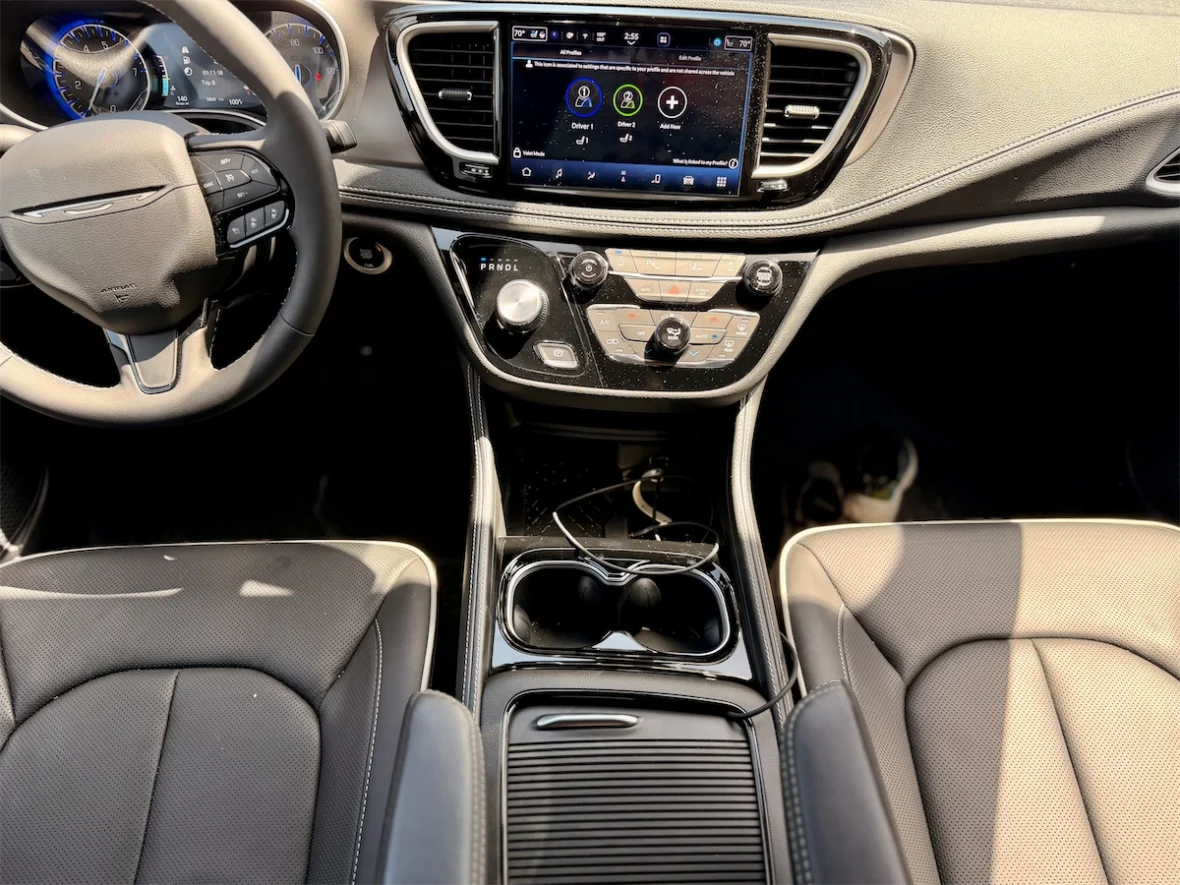 Uconnect 5 touchscreen and rotary shifter on the center console of a 2027 Chrysler Pacifica