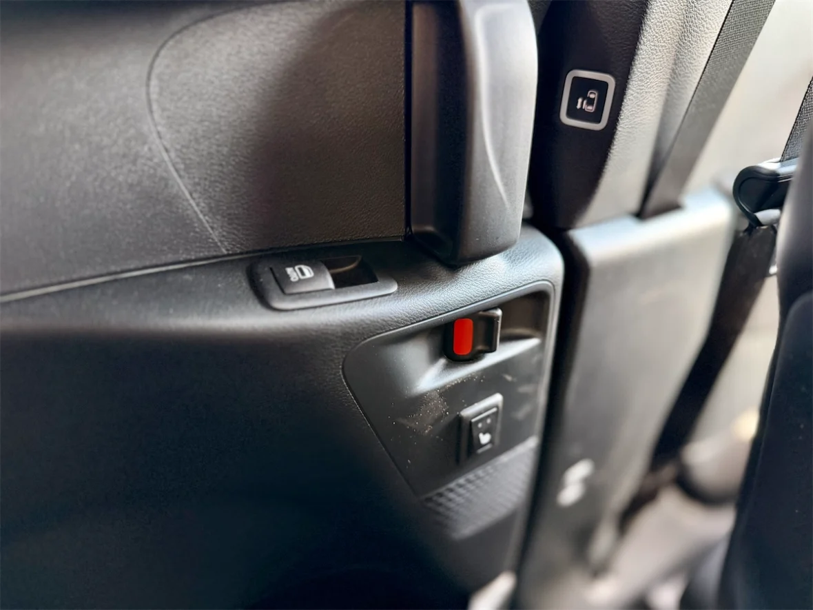 Second-row door panel with the Stow 'n Go seat release in a 2027 Chrysler Pacifica