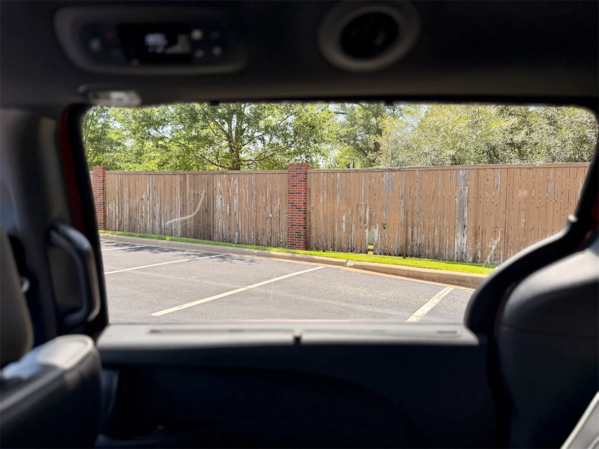 View out a lowered second-row window of a 2027 Chrysler Pacifica