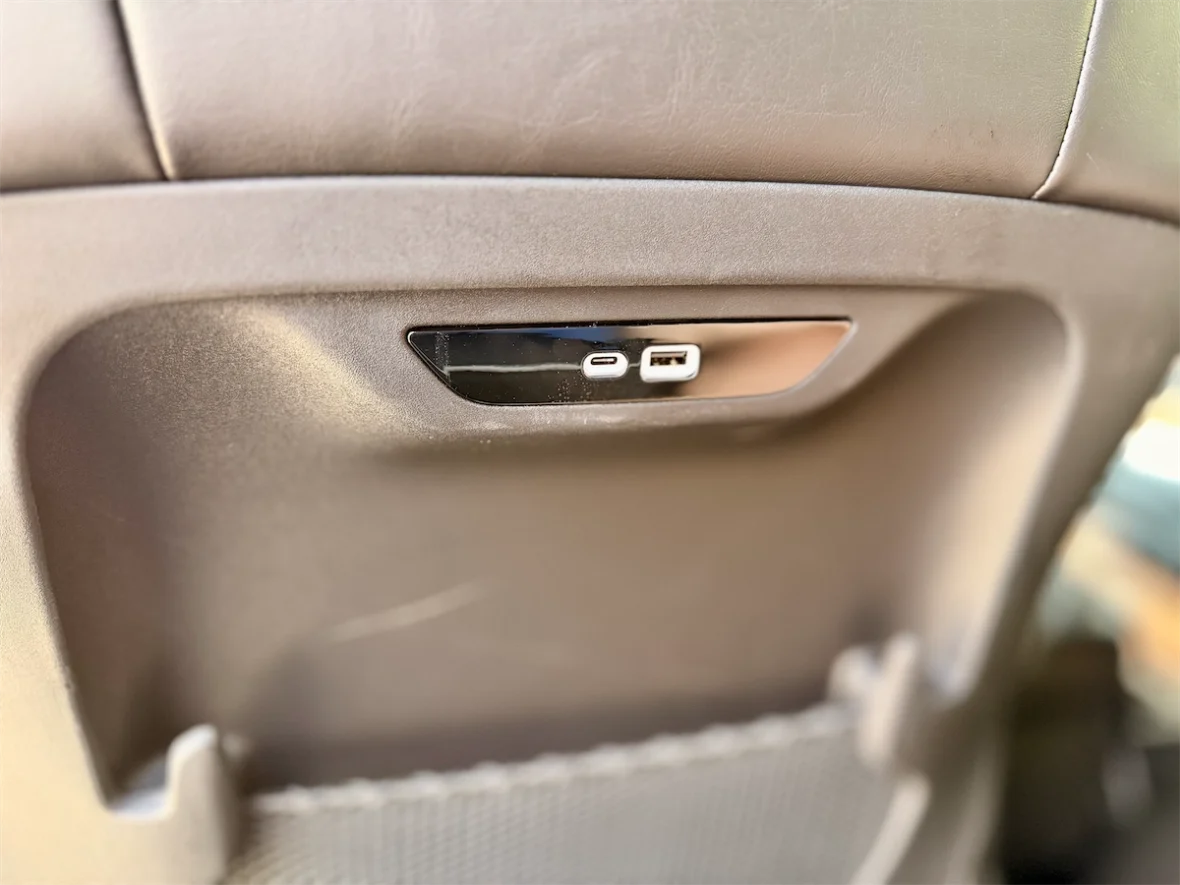 USB-C charging ports on the rear door panel of a 2027 Chrysler Pacifica