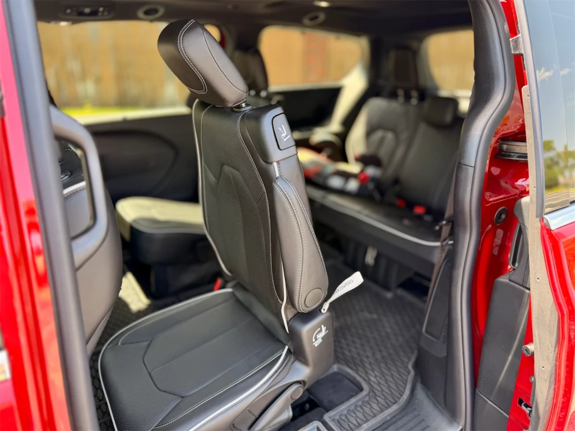 Child booster seat installed in a second-row captain's chair of a 2027 Chrysler Pacifica
