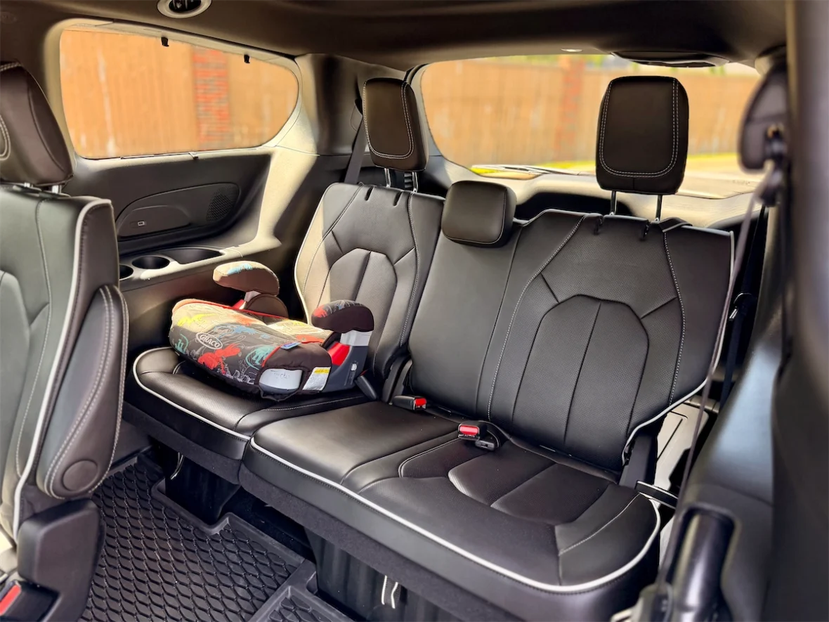 Child booster seat on the third-row bench of a 2027 Chrysler Pacifica