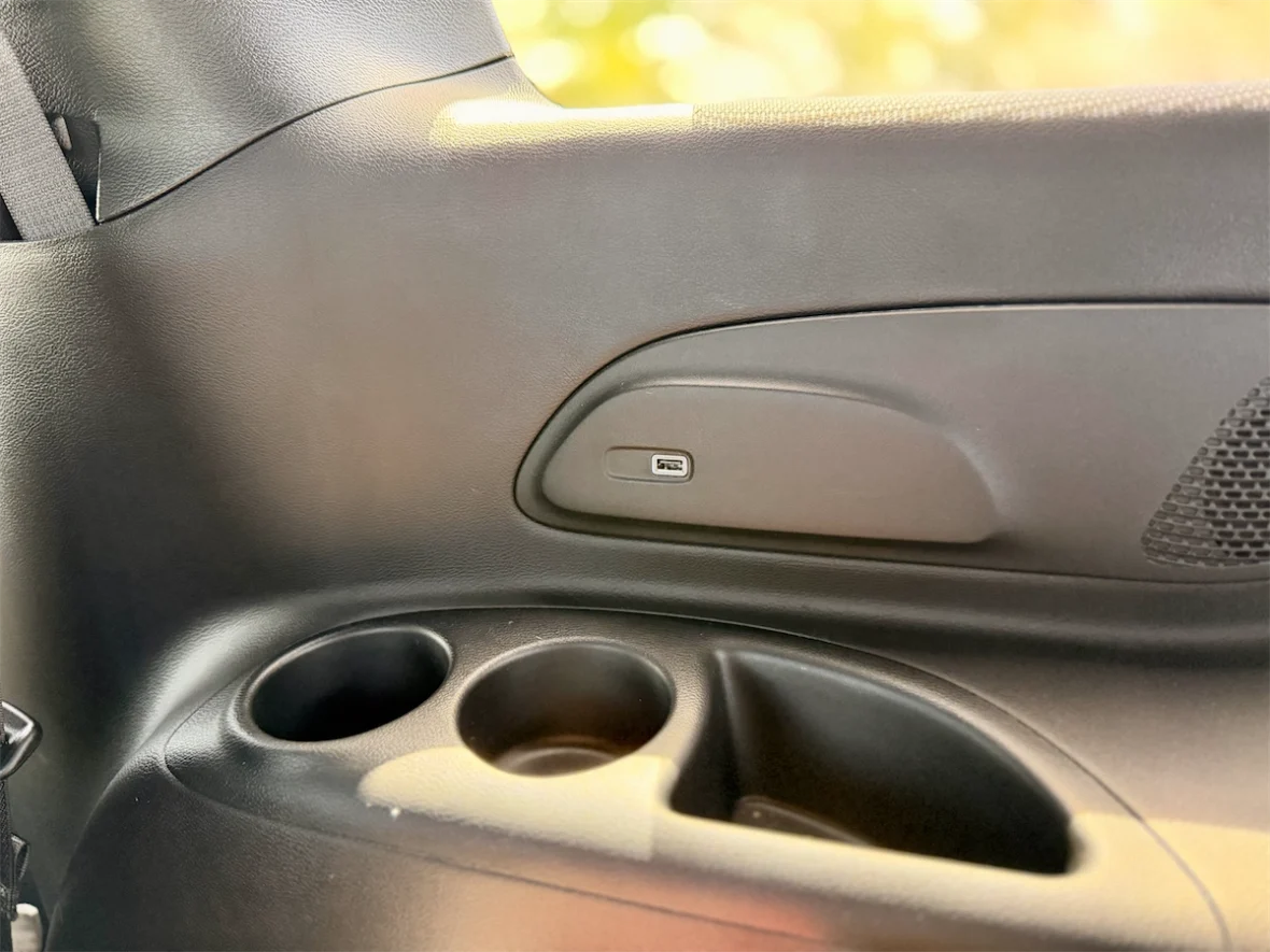 Second-row door panel with cupholders and controls in a 2027 Chrysler Pacifica
