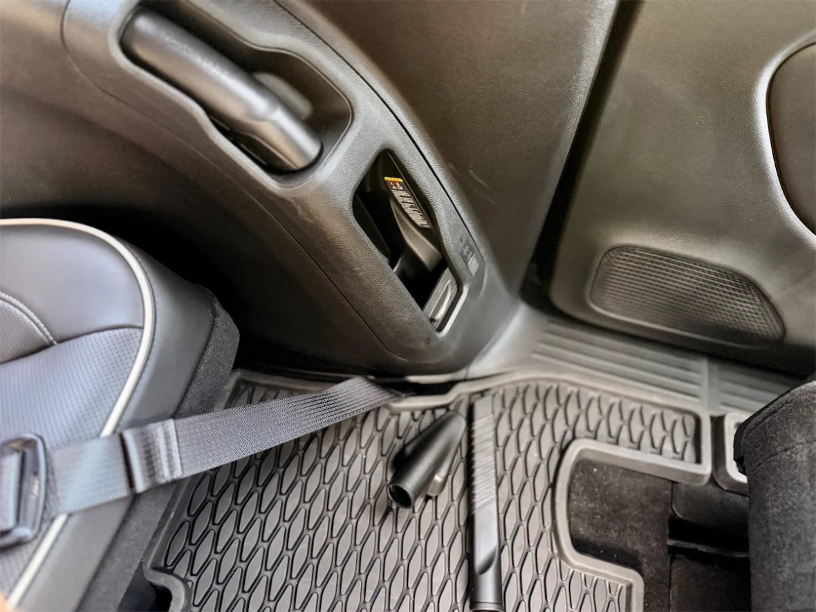 Integrated Stow 'n Vac hose on the second-row floor mat of a 2027 Chrysler Pacifica