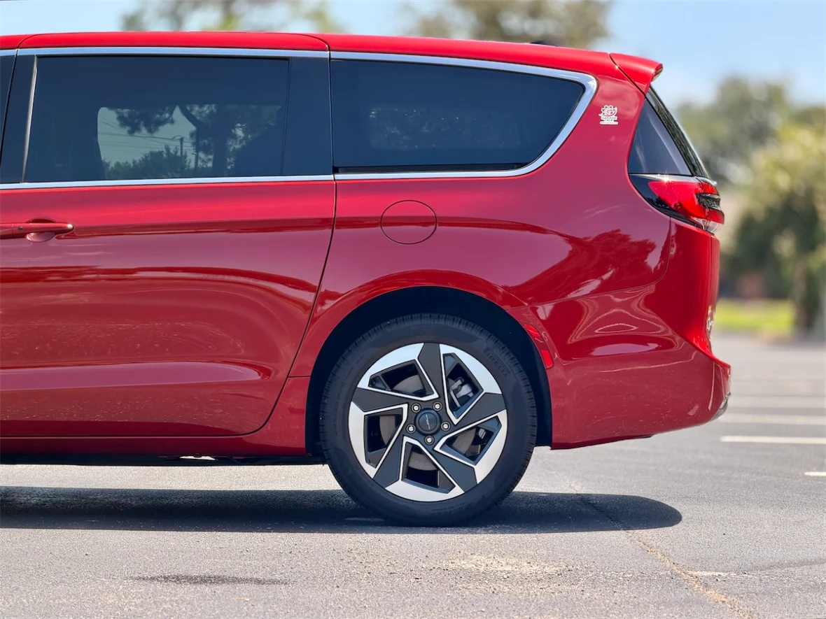 Rear three-quarter profile of a red 2027 Chrysler Pacifica
