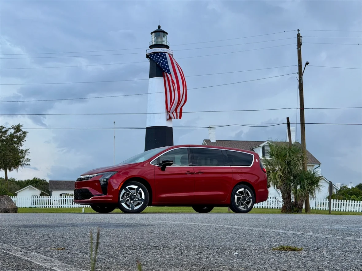 Red 2027 Chrysler Pacifica in front of the striped Tybee Island Light with an American flag