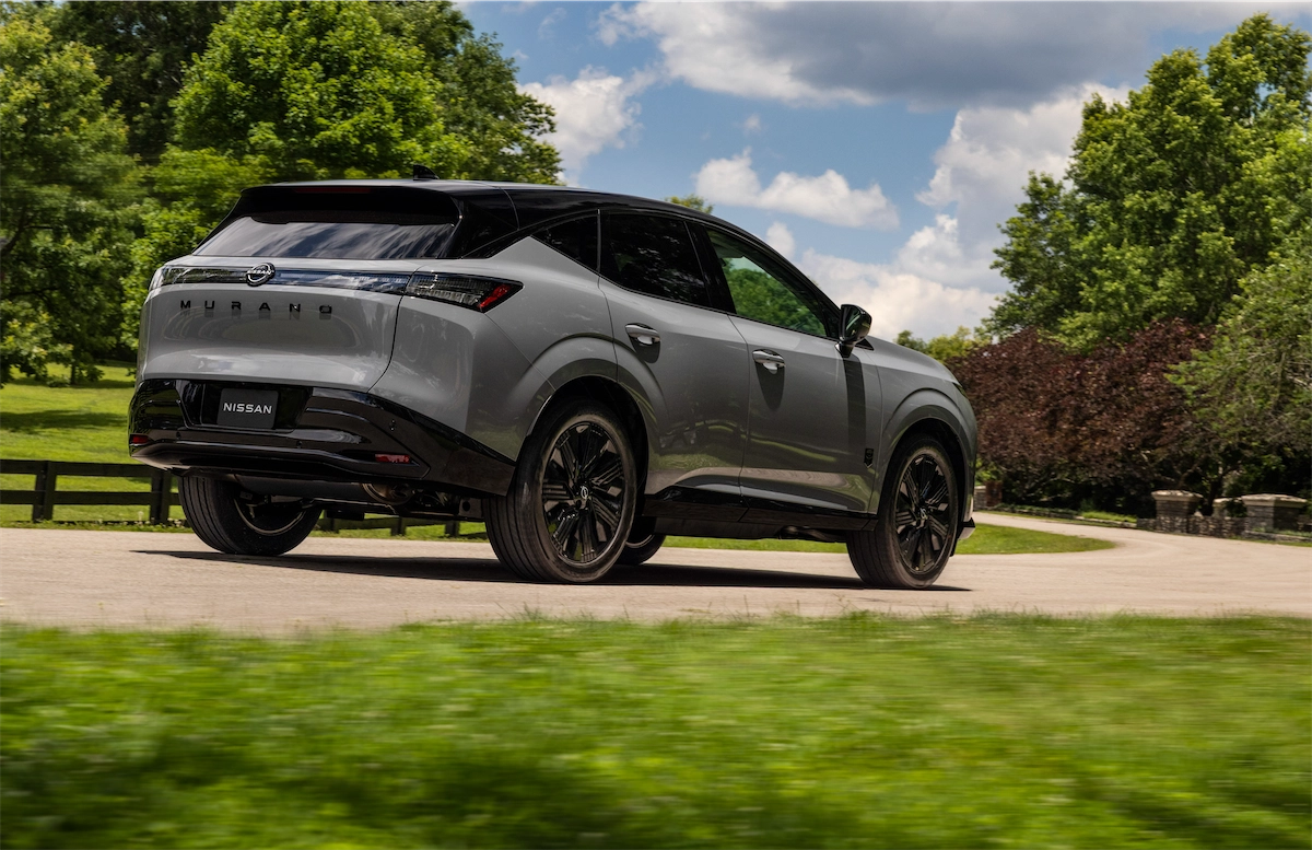 2027 Nissan Murano Dark Armor driving on a tree-lined road