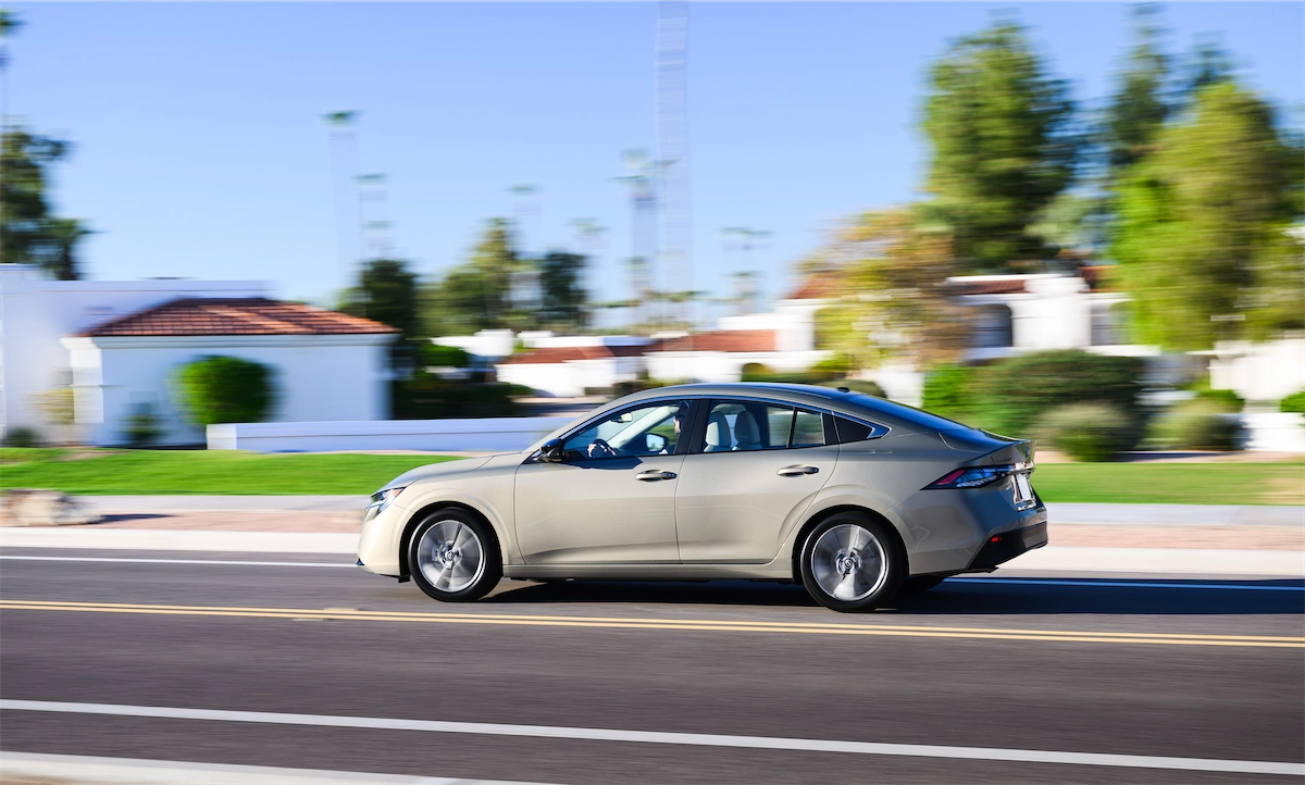 Silver compact sedan in motion on a city street