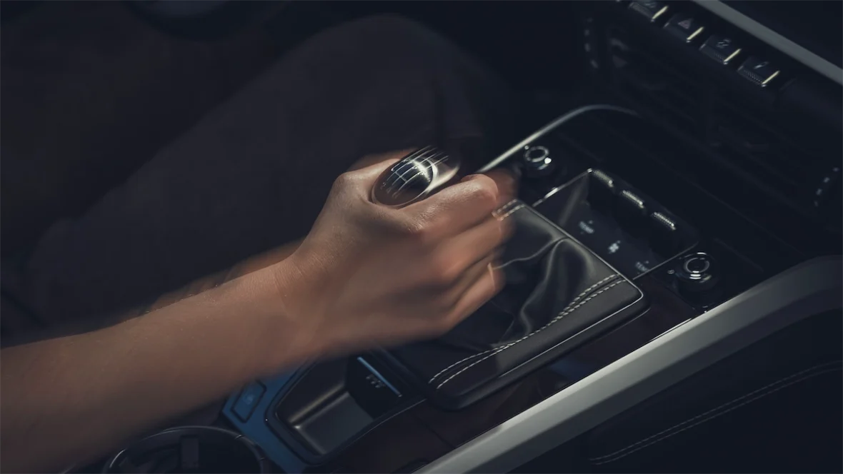 Driver shifting the six-speed manual in the 911 Carrera S