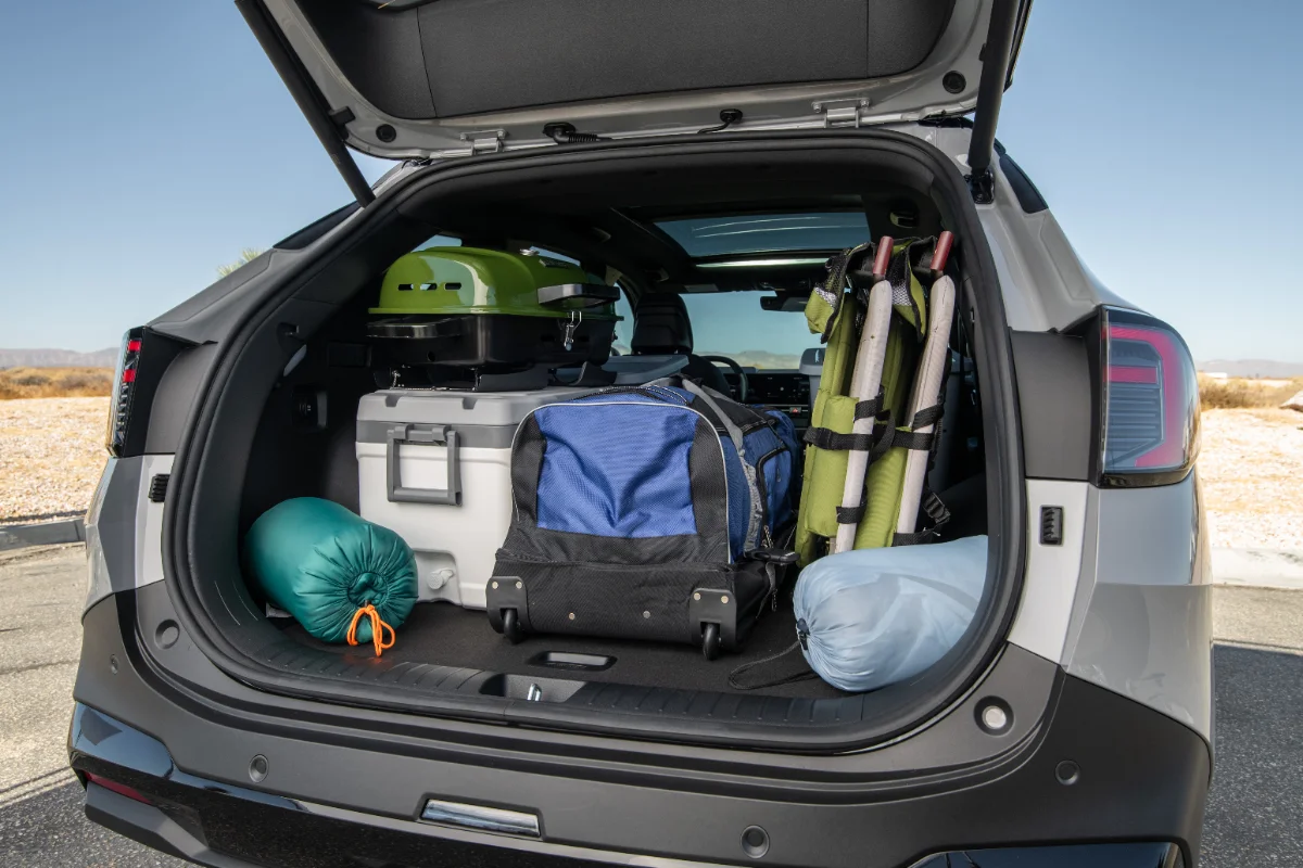 SUV cargo area packed with camping gear and coolers