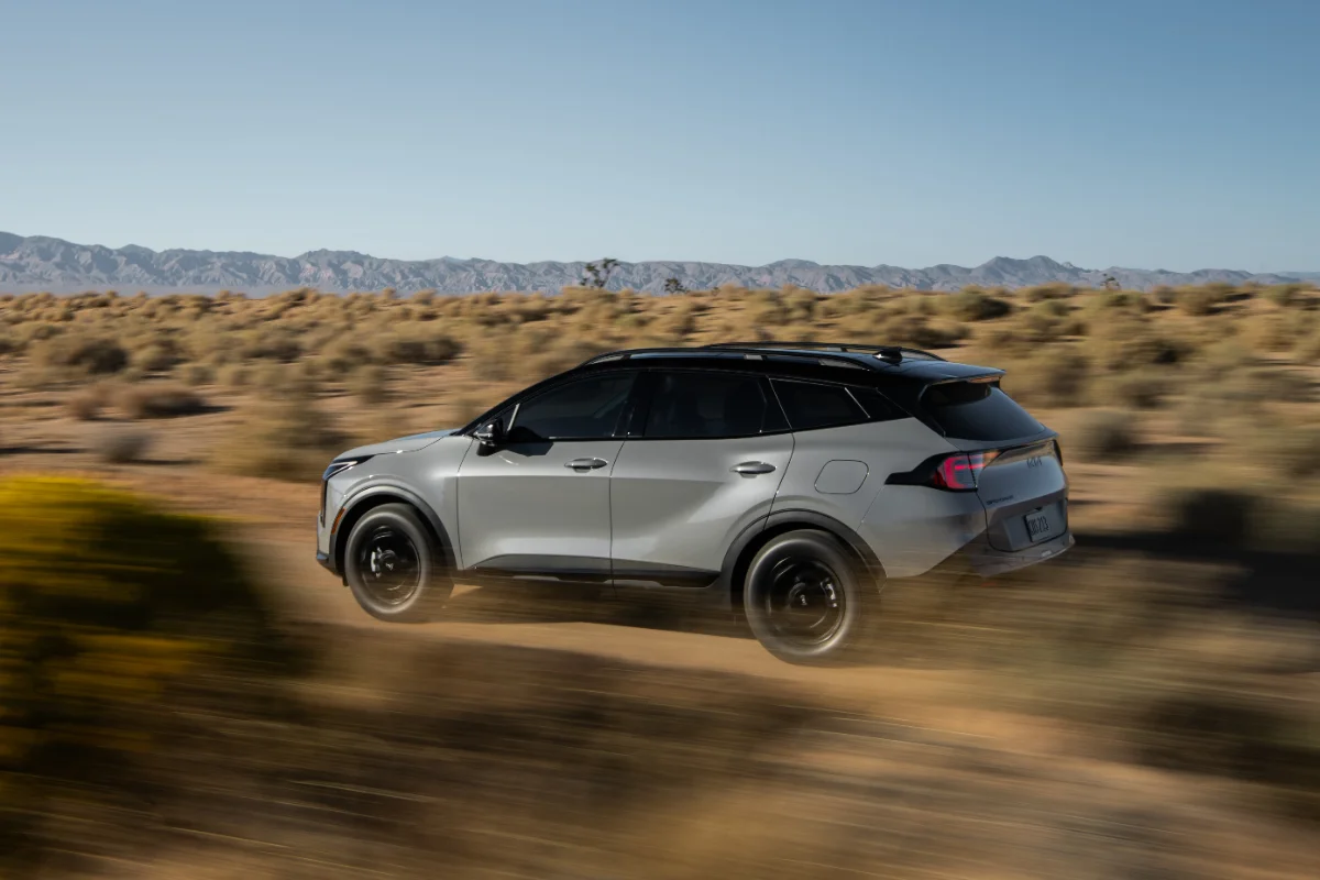 Compact SUV kicking up dust on a desert road