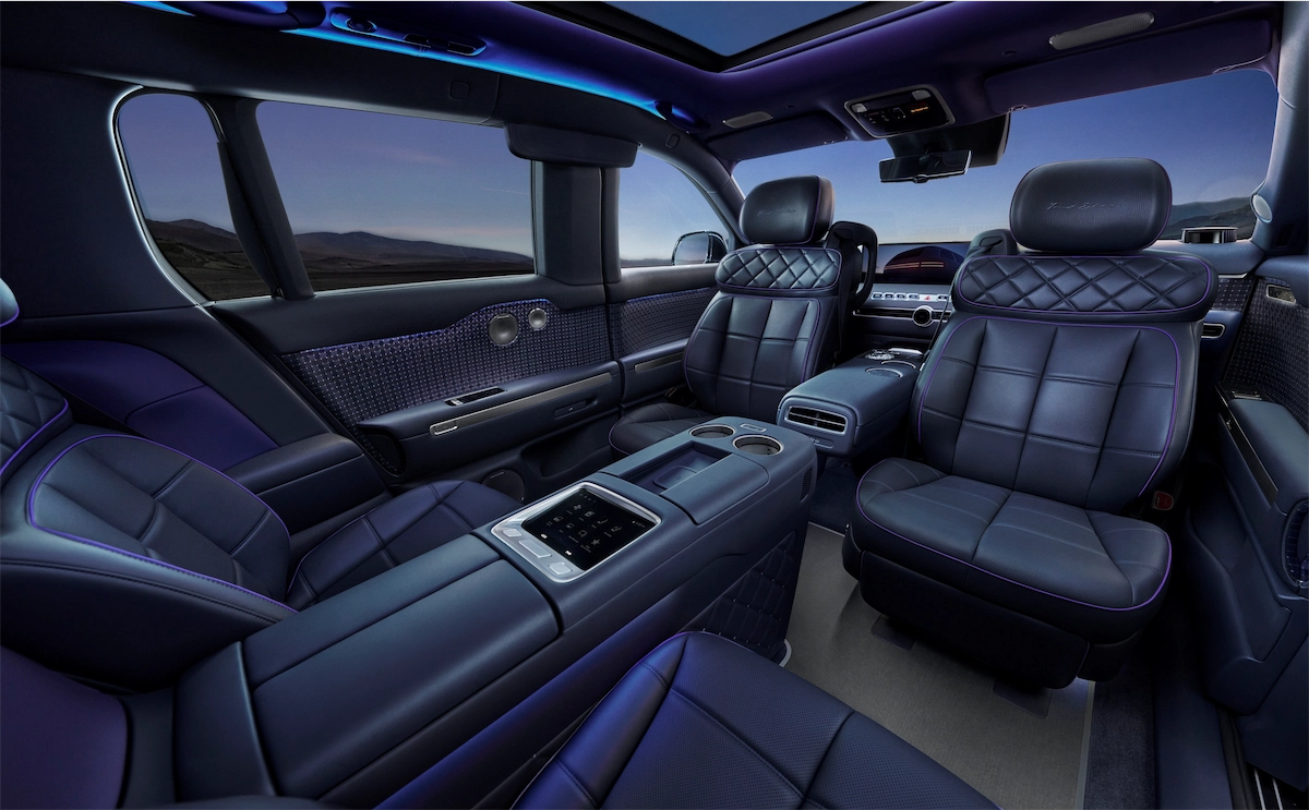 Navy diamond-quilted captain’s chairs and center console in a luxury SUV second row