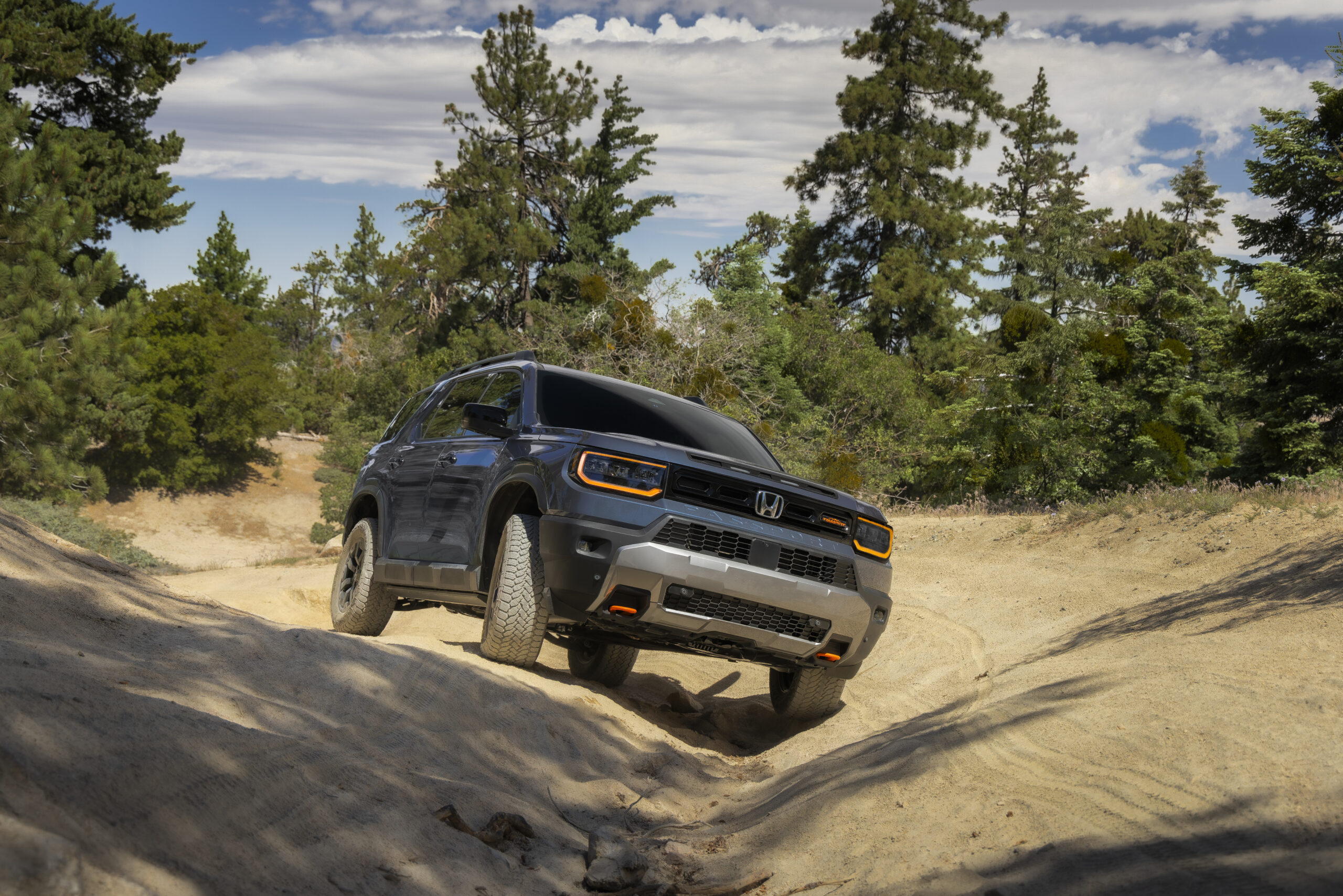 2027 Honda Passport TrailSport climbing a dirt trail