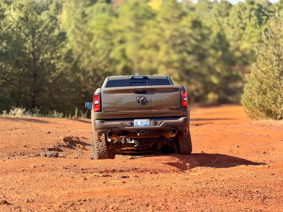 Rear view of a pickup truck on a red dirt trail in East Texas