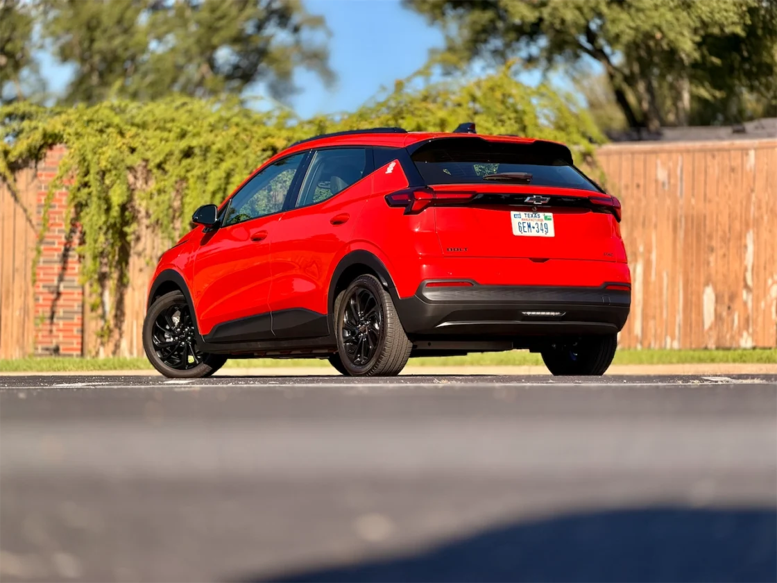 2027 Chevrolet Bolt RS rear three-quarter with blacked-out bowtie