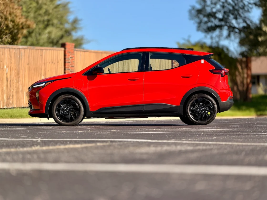 2027 Chevrolet Bolt RS side profile in Habanero Orange