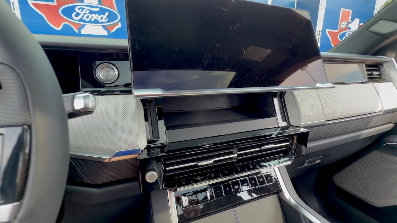 Passenger display lifted to reveal hidden storage in the Sierra Denali dash