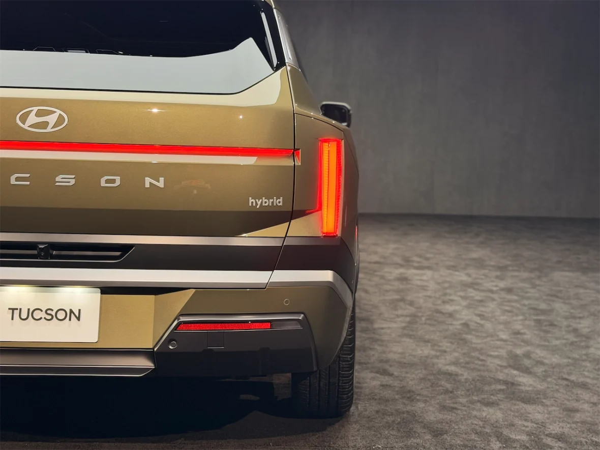Rear view of a Hyundai Tucson hybrid showcasing its sleek design and modern taillights.