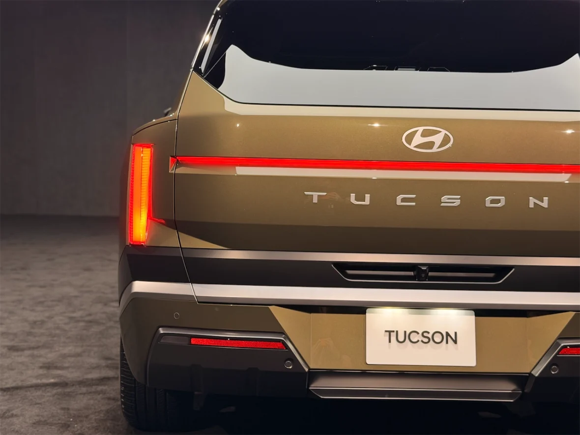 Rear view of a Hyundai Tucson SUV displaying its sleek design, featuring modern taillights and the model name 'TUCSON' prominently displayed.
