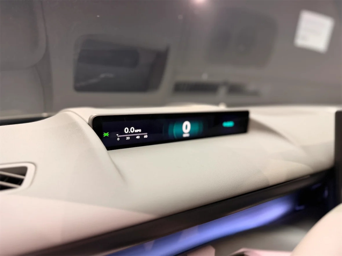 Dashboard display showing fuel efficiency at 0.0 MPG in a modern vehicle.