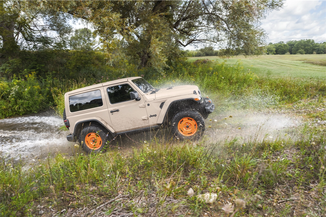 2027 Jeep Wrangler JL-2A splashing through water off-road