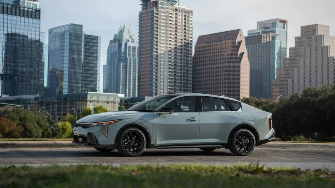 2027 Kia K4 sedan in front of a city skyline