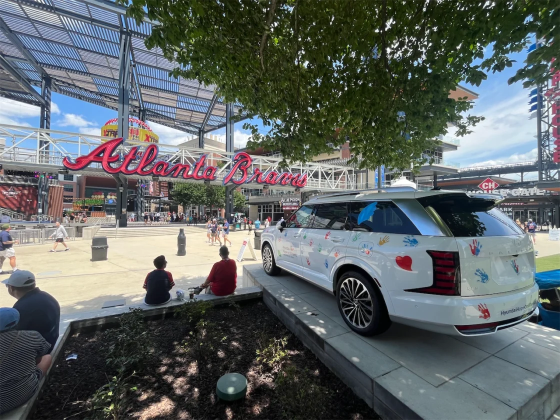 Hyundai Hope on Wheels Palisade beneath the Atlanta Braves sign at The Battery Atlanta