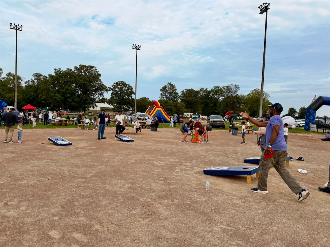 Families play cornhole and lawn games during the Ford Community Field celebration on Belle Isle.