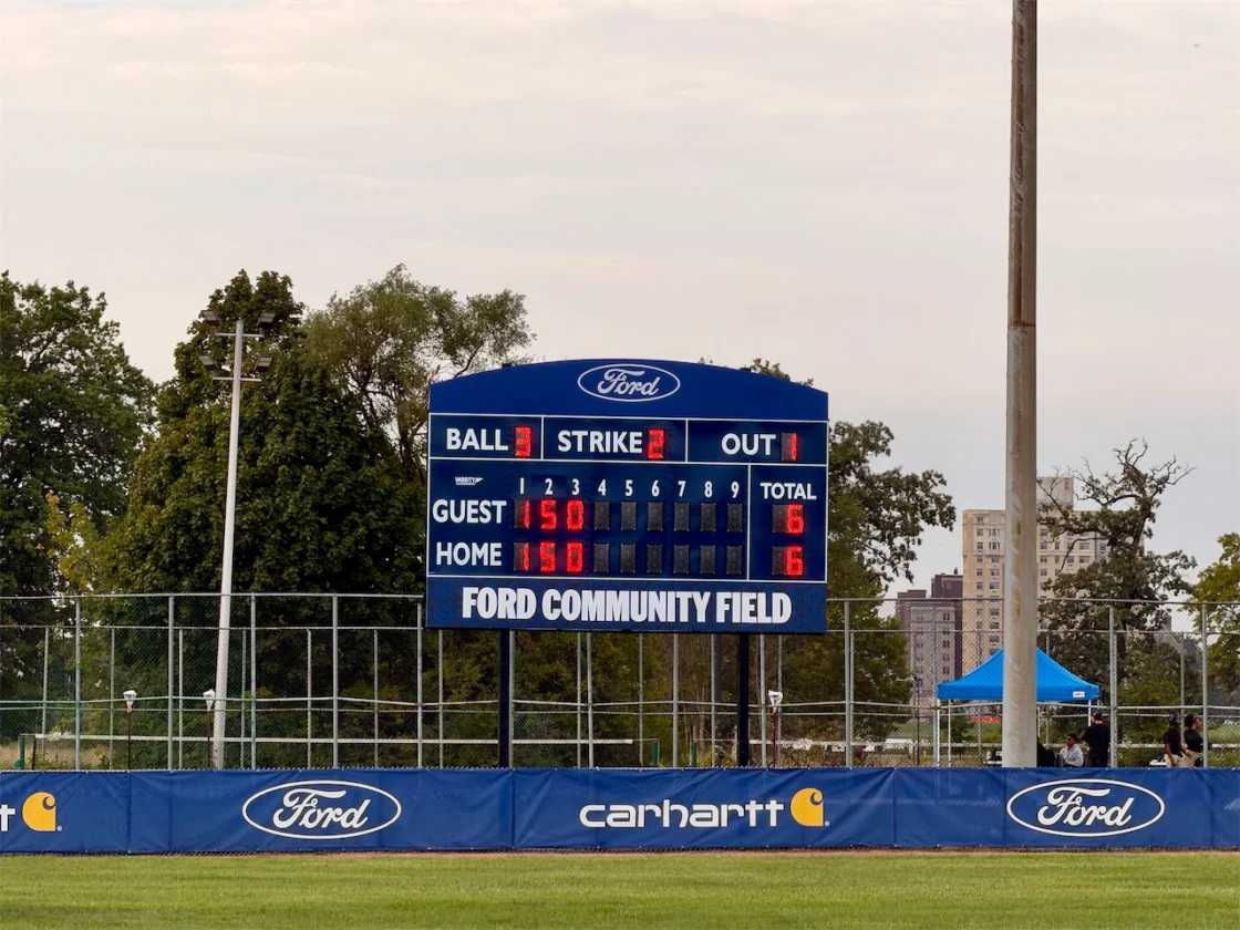 The Ford Community Field scoreboard stands behind the renovated outfield fence on Belle Isle in Detroit.