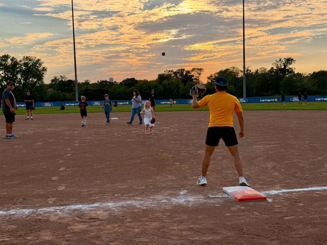 Young players take the field at sunset at the renovated Ford Community Field on Belle Isle.