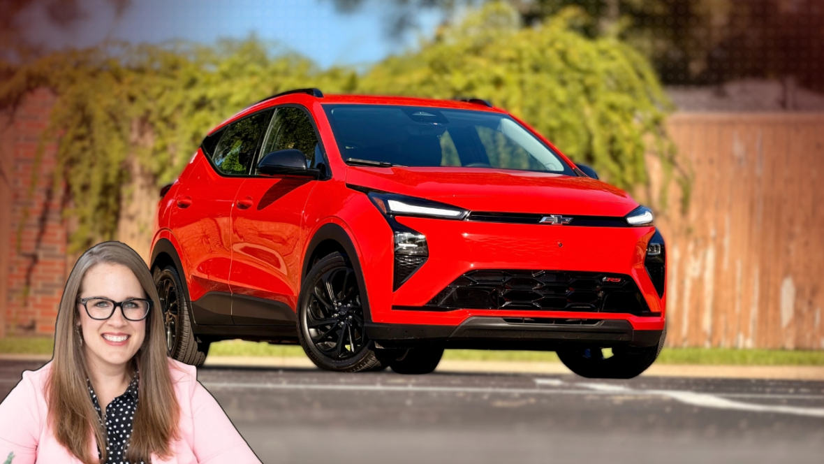 Holli with the 2027 Chevrolet Bolt RS in Habanero Orange