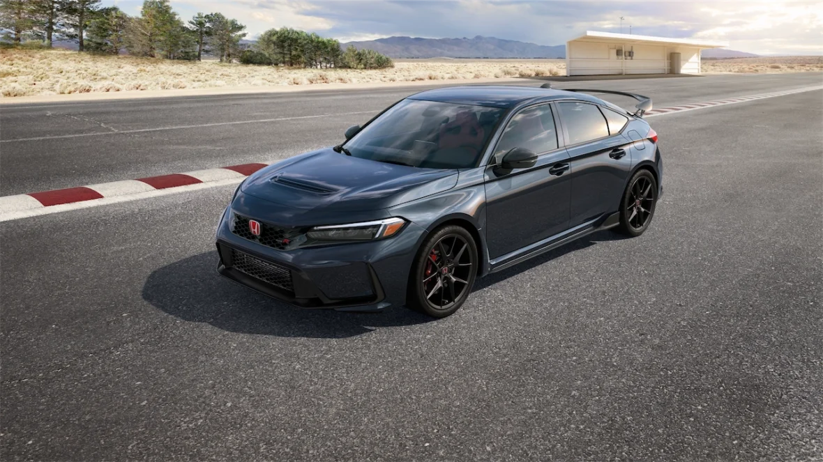 Dark gray Civic Type R parked on a racetrack beside red and white curbing
