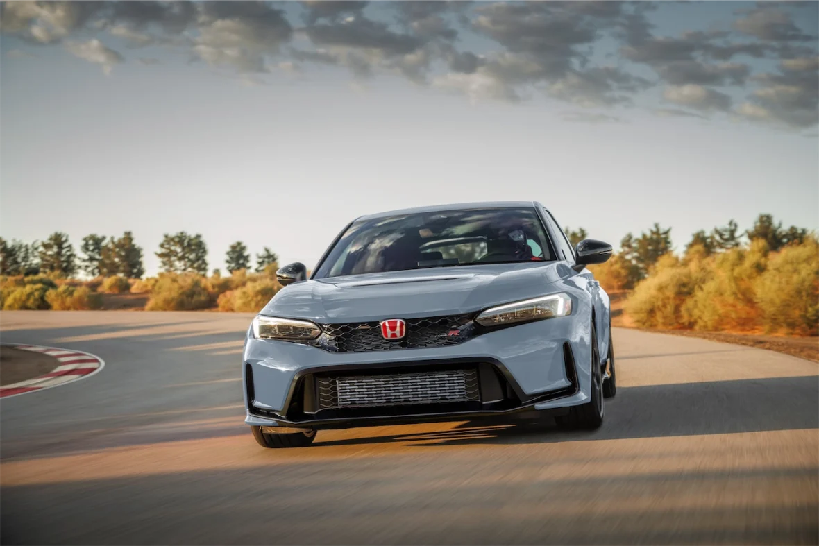 Sonic Gray Pearl Civic Type R driving through a curve on a track