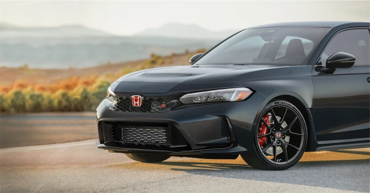 Front view of a dark gray 2027 Honda Civic Type R showing its redesigned fascia, larger grille opening, and red brake calipers