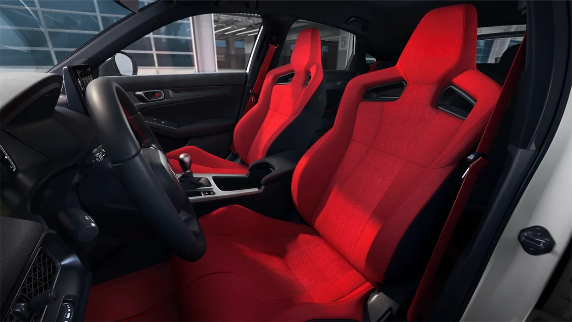 Civic Type R cabin with heated red sport seats, a black steering wheel, and the dashboard