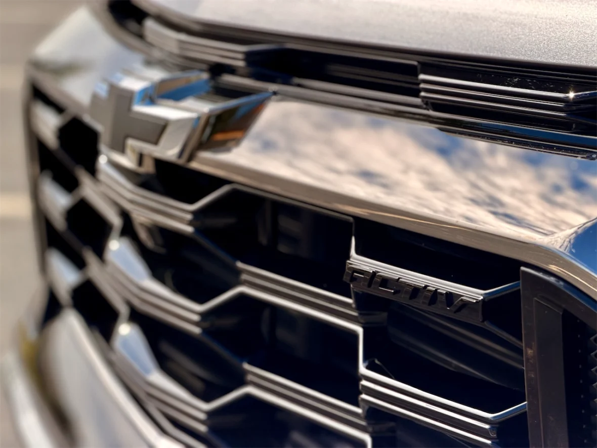 Close-up of a Chevrolet car's front grille showcasing the logo and sleek design elements.