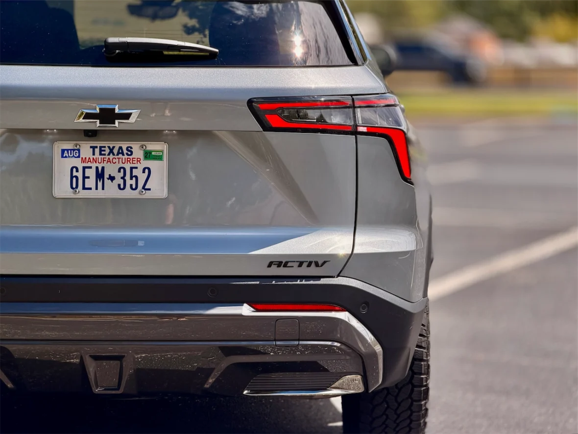 Rear view of a silver Chevrolet SUV displaying the license plate from Texas, featuring the word 'ACTIV' on the side.